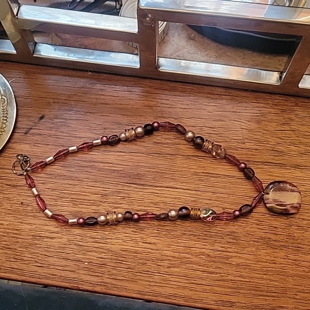 Pink glass, stone, and meal bead necklace with colored pink center stone